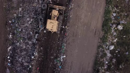 Bulldozer Works at Polluted Landfill, Aerial View