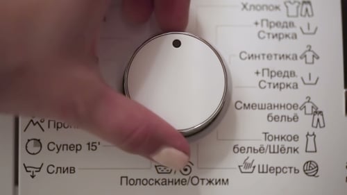 Hand Turning Washing Machine Appliance Dial