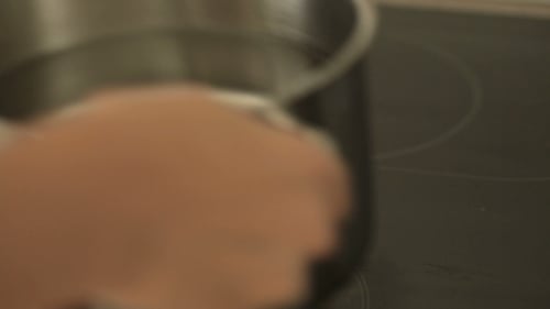 Woman Put The Pan Of Water On The Kitchen Stove