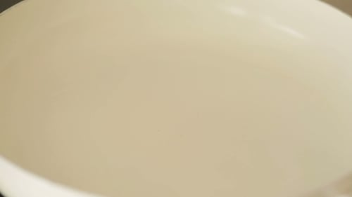 Onions Sauteing in Oil Inside a Pan