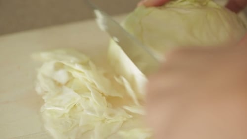 Slicing Fresh Cabbage on Cutting Board
