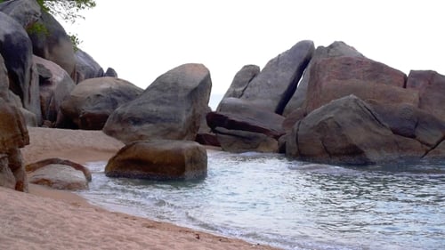 Waves Wash onto Rocky Beach Shoreline