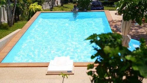 Young Woman Relaxing In The Outdoor Pool. Vacation