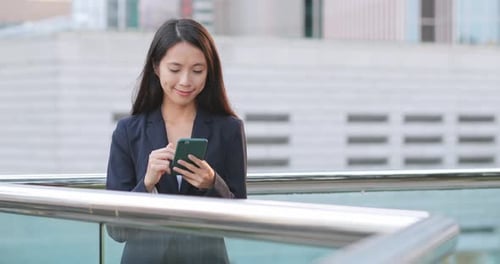 Woman Using Cell Phone in City