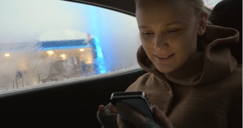 Blonde Woman Riding in Car Using Mobile Phone