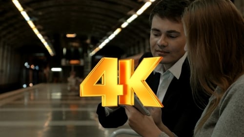 Man and Woman Using Tablet at Train Station