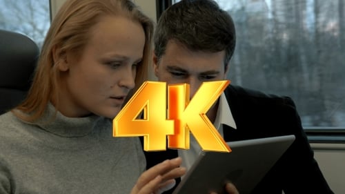 Man and Woman Using Tablet on Train