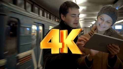 Couple Using Tablet in Urban Subway Station