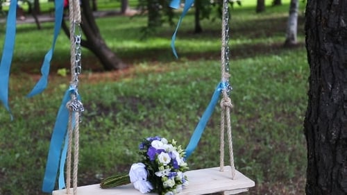 Wedding Bouquet on Swing in a Green Park