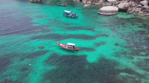 Boats Anchoring in Turquoise Shallow Water By the Edge of Coral Reef