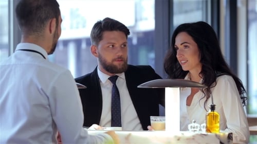 Colleagues Discuss Business in Bright Urban Restaurant