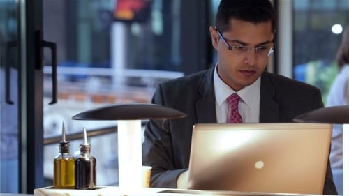 Businessman Working With Laptop In Cafe
