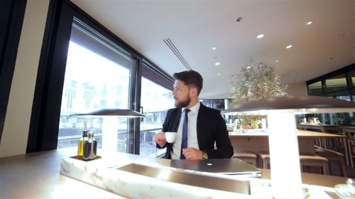 Handsome Man Working at Laptop in Modern Workspace