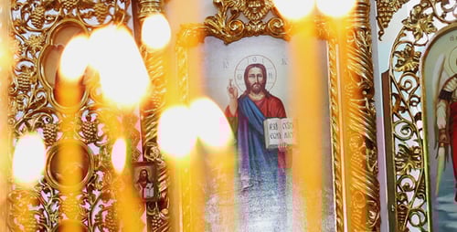 Candles Burning in Front of Religious Icons