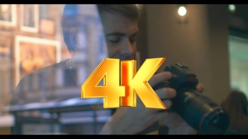 Young Adult Holding DSLR Camera Indoors