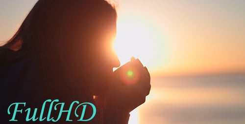 Woman Drinking A Hot Drink At Dawn