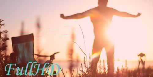 Silhouetted Man at Water's Edge During Golden Hour