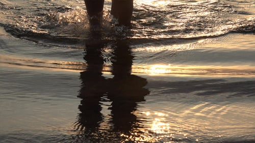 Woman in Sea at Sunset