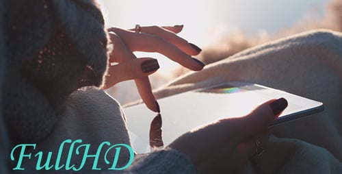 Woman Uses Tablet in Natural Sunlight Outdoors