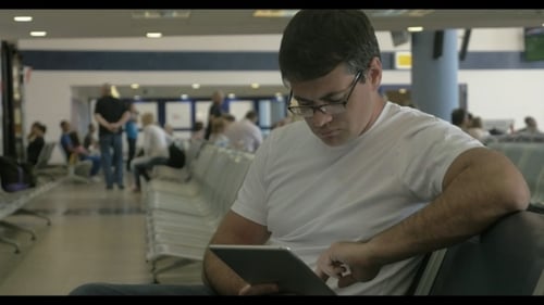 Man Using Tablet in Busy Airport Terminal