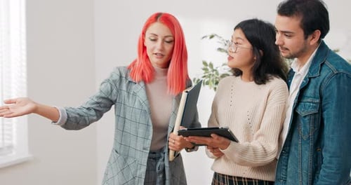 Meeting with a Real Estate Agent Young Couple Looking for an Apartment to Rent Buy in the City