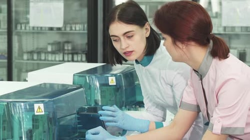 Scientists Collaborating on Medical Testing in Lab