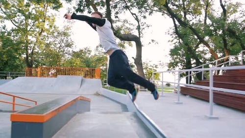 Young Man Doing Parkour Tricks in Extreme Sports Park