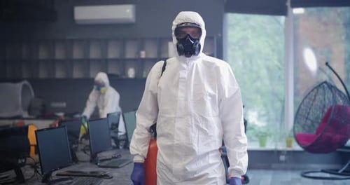 Hazmat Suit Cleaning Team Disinfecting Office Space