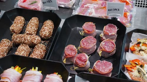 Close Up Appetizing Meat Products Are on Display in Special Containers. Meat Products for Sale in a