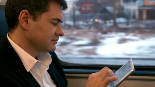 Man Using Tablet on a Train