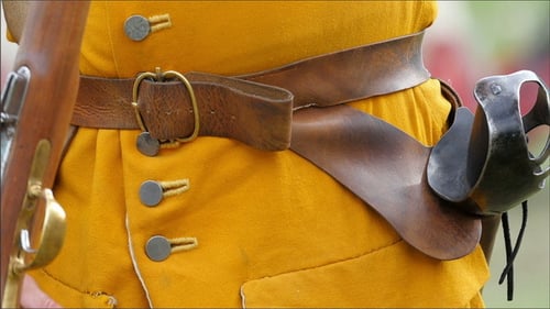 Man in Period Clothing Holding Flintlock Rifle