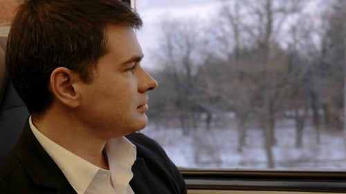 Man Looking Out Train Window at Winter Landscape