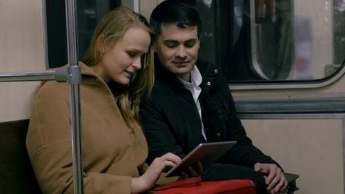 Young Couple Riding Subway Looking at Tablet