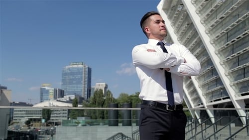 Young Businessman Standing Confidently in Urban Setting