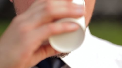 Close-up of Young Adult Man Drinking from Cup