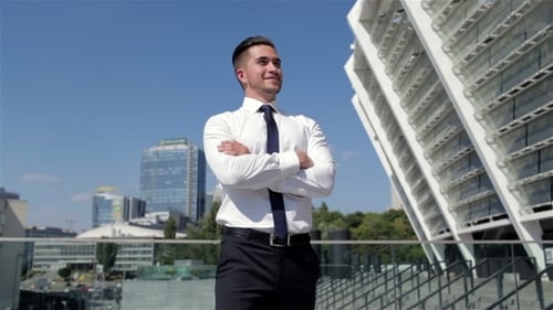 Confident Young Businessman Standing in City Environment