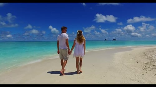 Man and lady posing on tropical bay beach break by blue green water with white sandy background of t