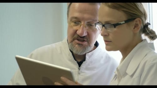 Male And Female Doctors Discussing Some Issue