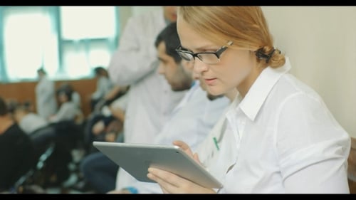 Woman Uses Tablet in Modern Office Setting