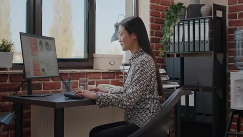 Woman Working at Computer in Modern Office