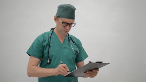 Medical Professional Writing on Clipboard in Hospital