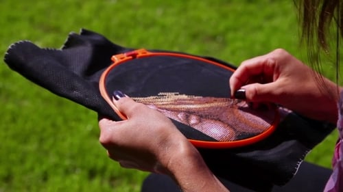 Woman Cross-Stitching Outdoors in the Daytime