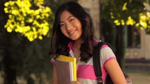 Smiling Student Waving on College Campus