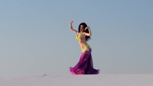 Woman Belly Dancing in Colorful Costume in Desert