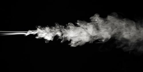 White Smoke Flowing Against a Black Background