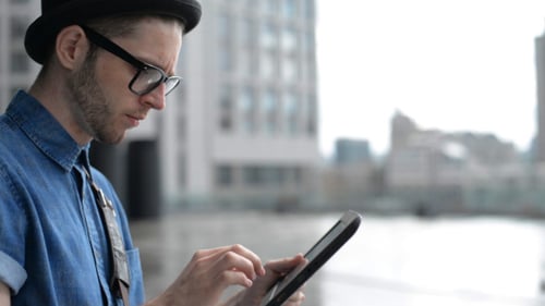 Typing on Tablet on Street