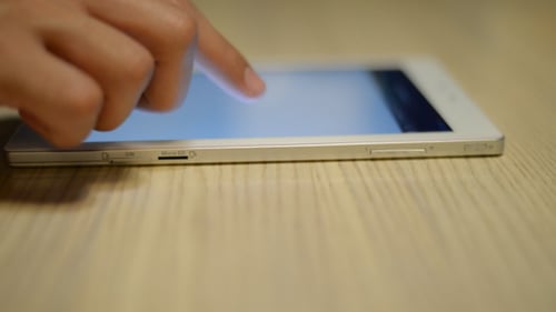 Hand Using Tablet on Table ( 1 )