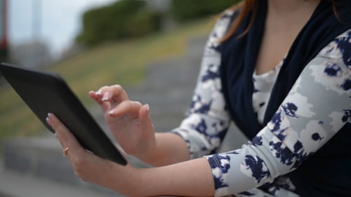 Woman Using Tablet Outdoors in the City