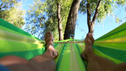 Man Relaxing in Hammock on a Sunny Day