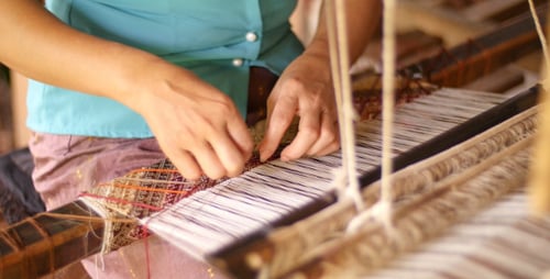 Woman Weaving On Loom